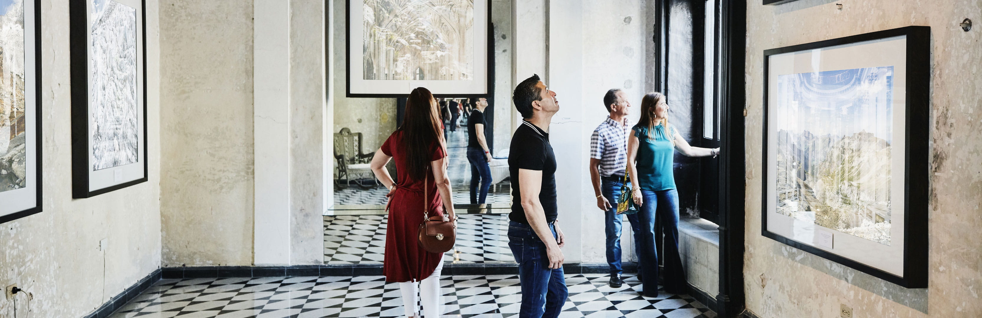 Visitors explore an art gallery, reflecting how charitable giving helps preserve arts, culture and community access.