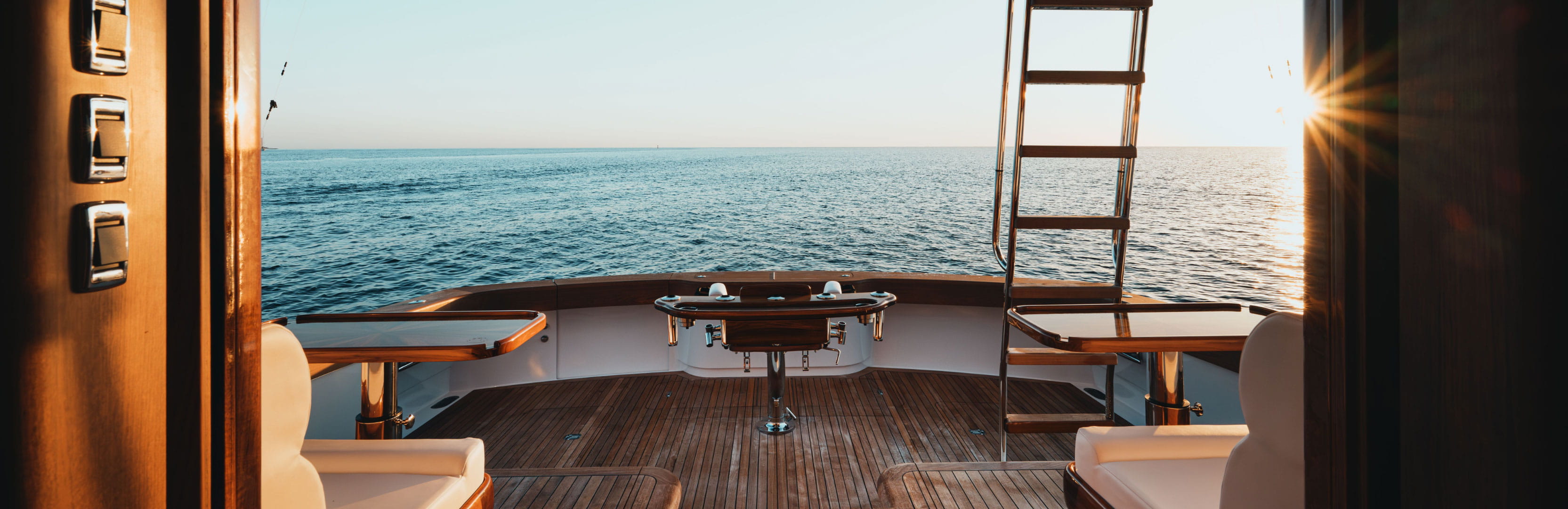 View from a chartered yacht overlooking calm open water at sunset, highlighting how yacht vacations are becoming more accessible for today's travelers seeking unique getaways.